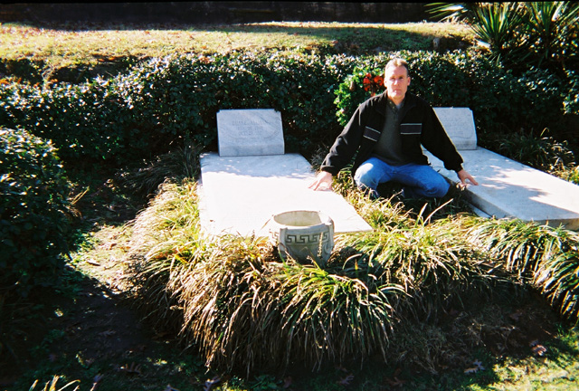 Me between the graves of two legends, Rose Hill Cemetery, Macon, GA, December 2003.