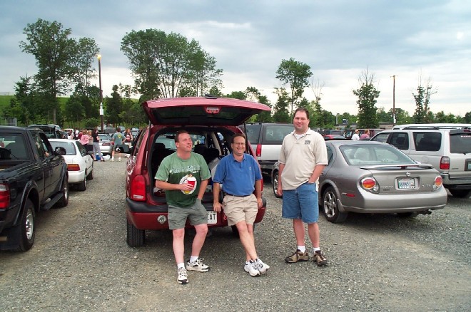 Steve, Mike and Jim draining my rum supply dry while I take their picture in the parking lot before the Nissan show on 6/27/03